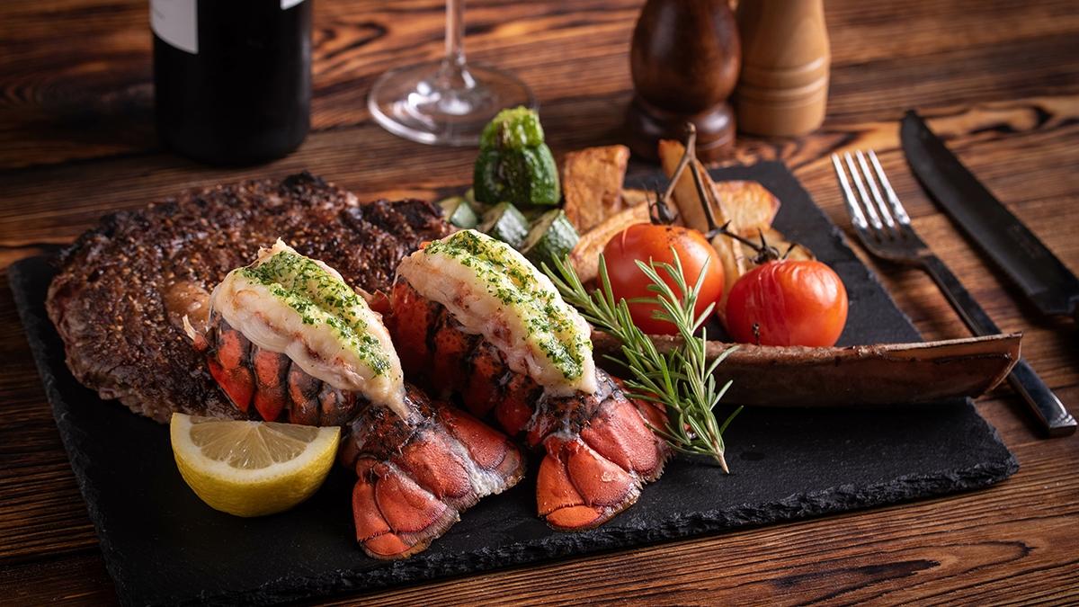 surf and turf with tomahawk rib eye steak and lobster tail