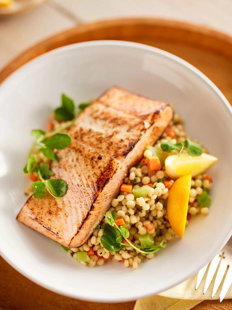 Omega  salmon in a bowl with rice and vegetables.