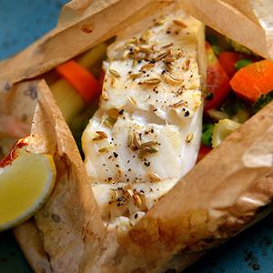 Fish recipes with a piece of white fish wrapped in parchment paper.