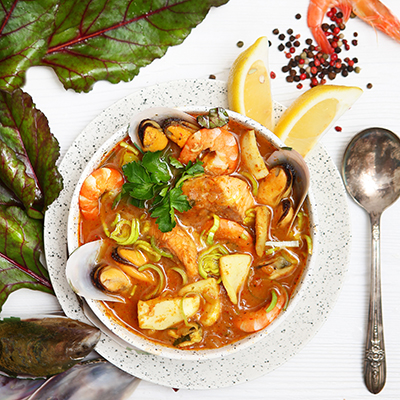 French fish soup. Bouillabaisse ear of seafood. Food French sailors. White background, top view. Free space for inscriptions. Still life concept.