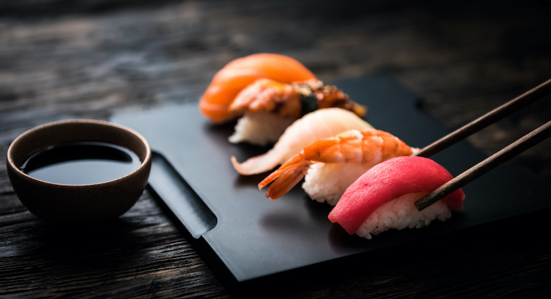 close up of sashimi sushi set with chopsticks and soy