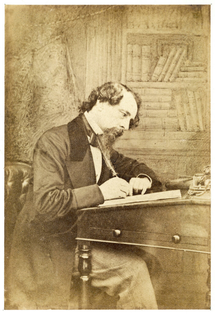 Benefits of walking, Charles Dickens at his desk writing, presumably after a long walk.