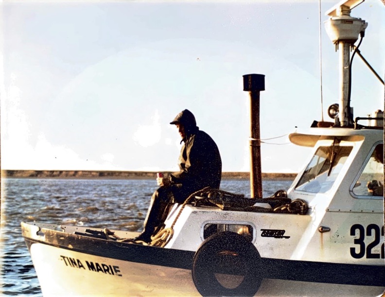 Vital Choice co founder, Dave Chapman, sitting on a boat in Bristol Bay.