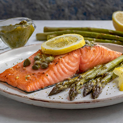 Fish sauces with a plate of salmon with lemon caper sauce and asparagus